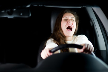 girl is afraid holding the steering wheel