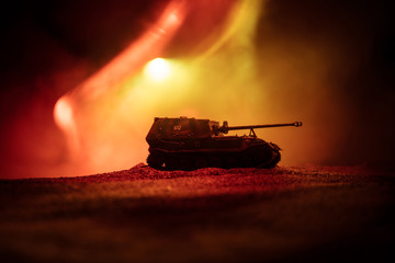 War Concept. Military silhouettes fighting scene on war fog sky background, Silhouette of armored vehicle below Cloudy Skyline At night. Attack scene. Tanks battle.