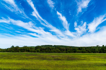 Clouds, Blue Sky Over Hill and Field