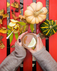 Female hands hold Ginger tea with lemon and honey. Traditional Autumn Drink