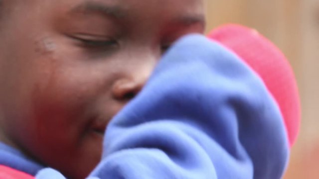 A kid crying and showing tears on her cheeck