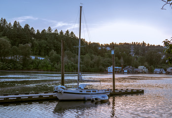 Fototapeta na wymiar A Sailboat docked near the Sellwood Bridge at Sunset in Portland Oregon