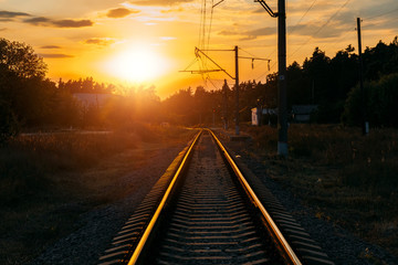 Fototapeta na wymiar Empty railway track in sunny summer sunset