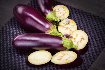 Dietary healthy food. Low-calorie product of healthy diet. Fresh sliced eggplant. Eggplant close up. Slices of eggplant with greens. Eggplant bloom..Healthy eating concept.