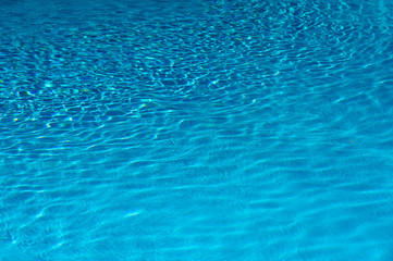Photo of ripple Water in swimming pool with sun reflection