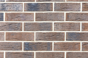 wall of brown smooth decorative brick, background, texture