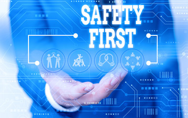 Handwriting text writing Safety First. Conceptual photo used to say that the most important thing is to be safe Male human wear formal work suit presenting presentation using smart device