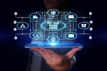 Word writing text Put Your Phone Down. Business photo showcasing end telephone connection saying goodbye caller Woman wear formal work suit presenting presentation using smart device