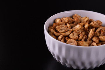 bowl with peanuts and black background