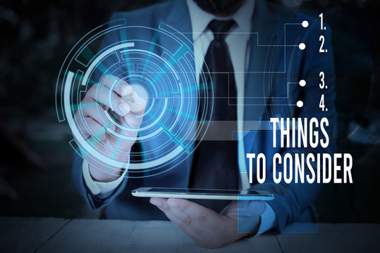 Writing note showing Things To Consider. Business concept for think about carefully especially in making decisions Male wear formal suit presenting presentation smart device