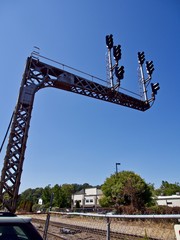 Railroad Signals Over Train Tracks Up Against a Blue Sky