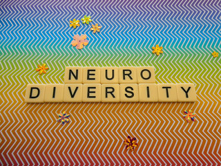 Bright rainbow zig zag pattern background sign with the word "NEURODIVERSITY" in text lettering, for a brilliant and eye catching sign or banner
