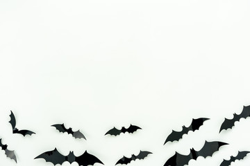 Table top view aerial image of decoration Happy Halloween day background concept.Flat lay accessories essential object to party the bat fly on white wooden wallpaper.Copy space for creative design.