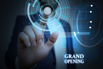 Handwriting text Grand Opening. Conceptual photo Ribbon Cutting New Business First Official Day Launching Male human wear formal work suit presenting presentation using smart device