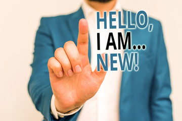 Word writing text Hello I Am New. Business photo showcasing used greeting or begin telephone conversation Businessman in blue suite and white shirt pointing with finger in empty space