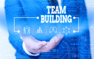 Handwriting text writing Team Building. Conceptual photo various types of activities used to enhance social relations Male human wear formal work suit presenting presentation using smart device