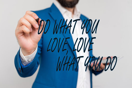 Text sign showing Do What You Love Love What You Do. Business photo showcasing Pursue your dreams or passions in life Businessman in blue suite and white shirt pointing with finger in empty space