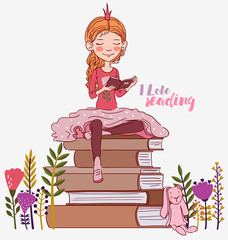 Cute little girl with crown reading a book. Beautiful princess 