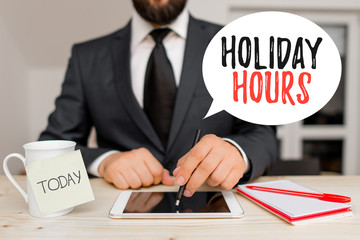 Obraz premium Writing note showing Holiday Hours. Business concept for employee receives twice their normal pay for all hours