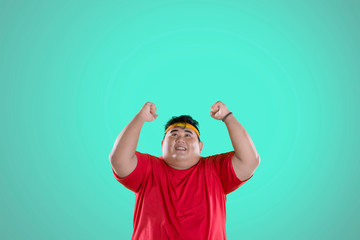 Naklejka premium Obese man expressing his success to lose weight