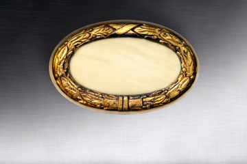 Close up shot of blank brass nameplate isolated over metal surface