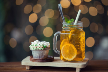 Lemon iced tea on wooden plate