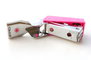 Small pink stapler isolated on white background.