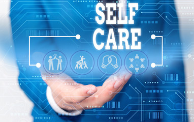 Handwriting text writing Self Care. Conceptual photo the practice of taking action to improve one s is own health Male human wear formal work suit presenting presentation using smart device