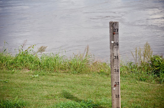 Water Level Measuring Stick Next To A River