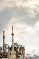 Fototapeta na wymiar Cityscape image of Istanbul Bosphorus view with Bosphorus bridge and Ortakoy Mosque over cloudy sky in Turkey