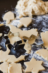Hanukkah dreidel and star of David homemade cookie dough being cut
