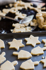 Hanukkah dreidel and star of David homemade cookie dough being cut