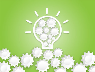 Creative Idea Concept. White light bulb and gear wheel on green background.