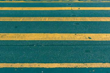 yellow crosswalk for pedestrian with asphalt road. tone photo