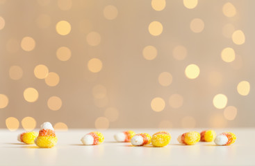 Fototapeta na wymiar Halloween theme with candies on a shiny light background