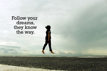 Dream Inspirational quote - Follow your dreams, they know the way. With young woman walking and ...