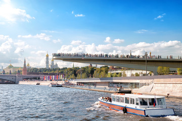 moscow city russia kremlin cityscape with people on bridge over moskva river waters and pleasure boat full of tourists on sightseeing tour landscape street view of town center historical skyline