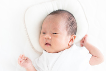 Baby lying on a crib