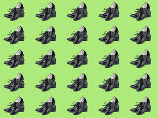 Elegant women's shoes with laces isolated on green background. Seamless pattern.