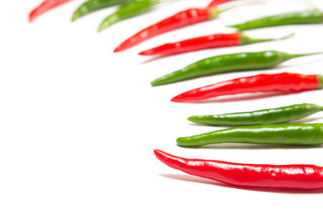 Red and green chili peppers on white background with copy space