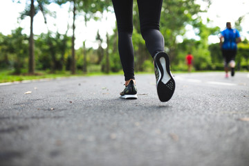 young fitness woman running at the park in morning.