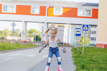 little girl rides inline skates