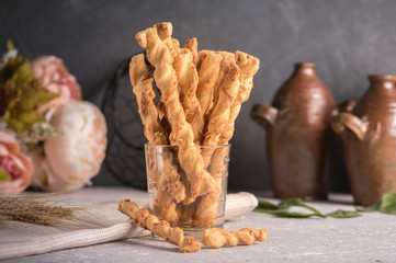 Homemade cheese bread sticks on a light background