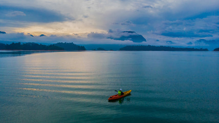 Fototapeta premium Kayaking on a lake aerial view water green