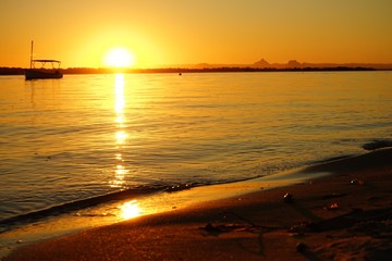 sun setting over calm water