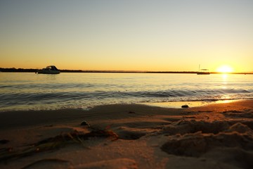 sun setting over calm water