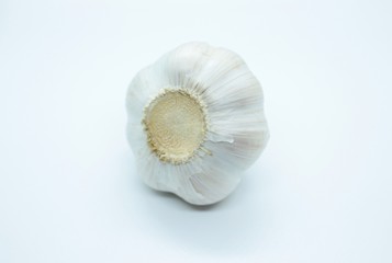 The head of garlic is located on a white background
