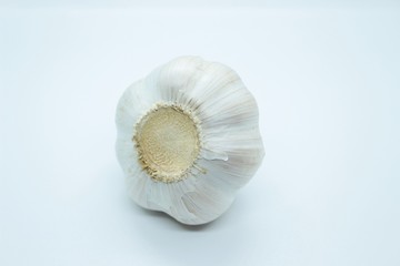 The head of garlic is located on a white background