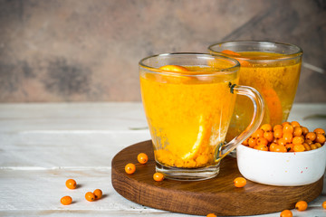 Sea buckthorn tea with orange in a glass cups.