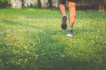 Close up. leg. man with runner on the street be running for exercise. wayside runner meadow